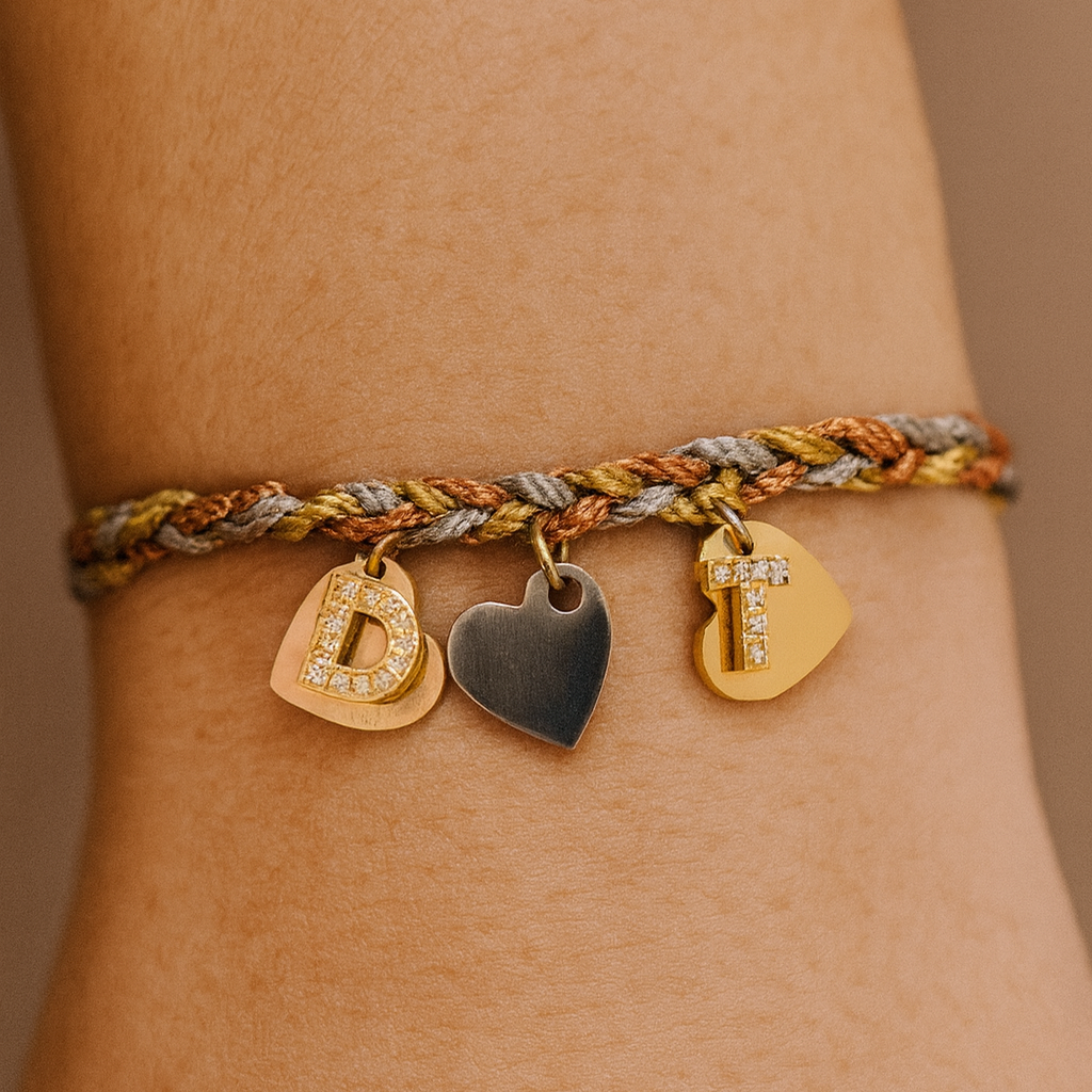 Silver gold and rose gold cord bracelets with gold diamanté initial and 3 tone metal hearts