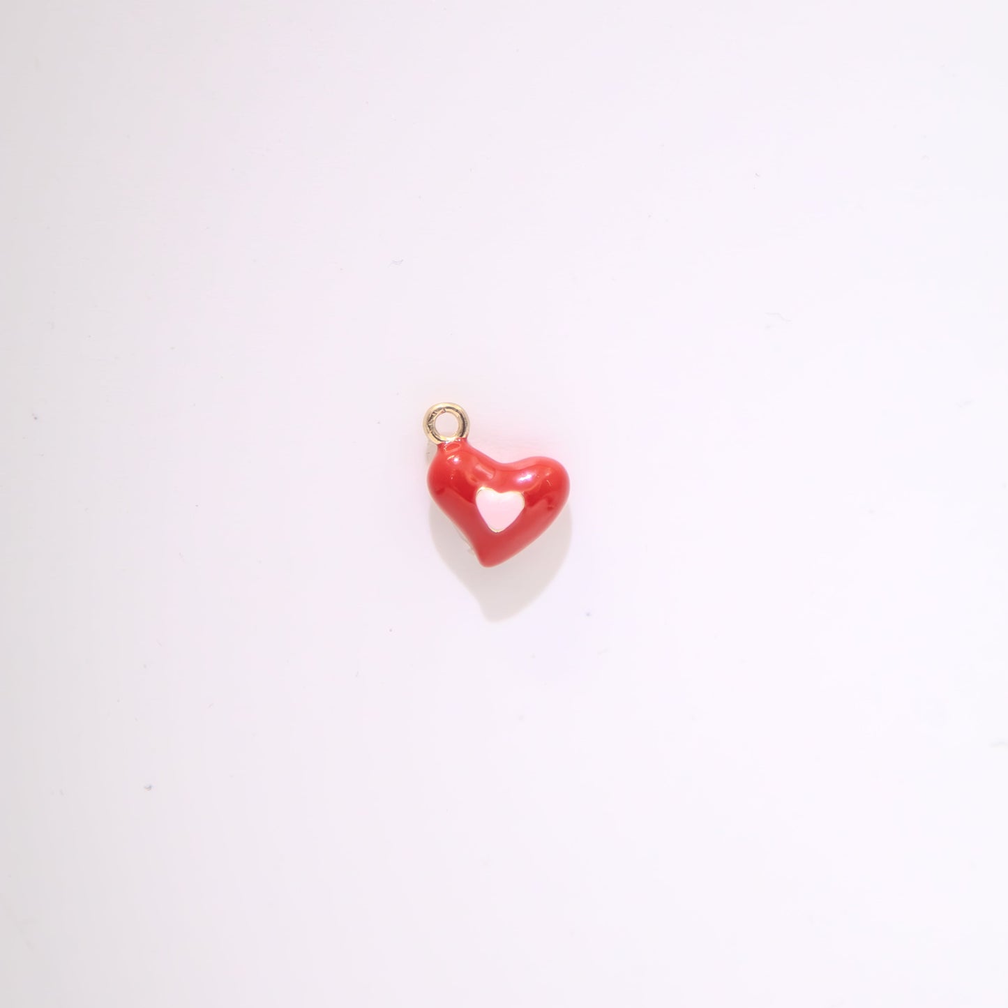 Red heart-shaped pendant with white centre