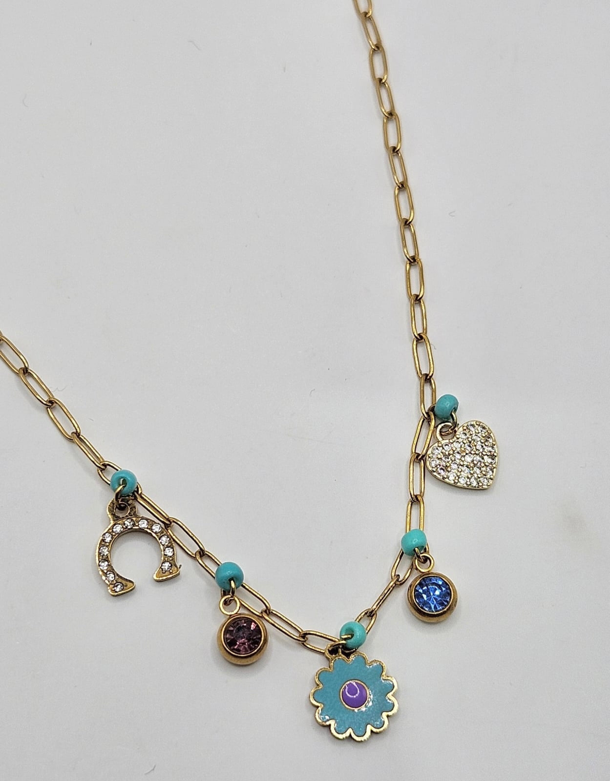 Gold necklace with blue and purple charms