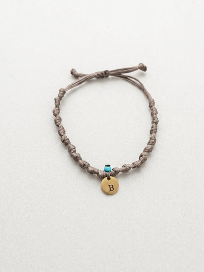 Knotted cord bracelet with gold initial