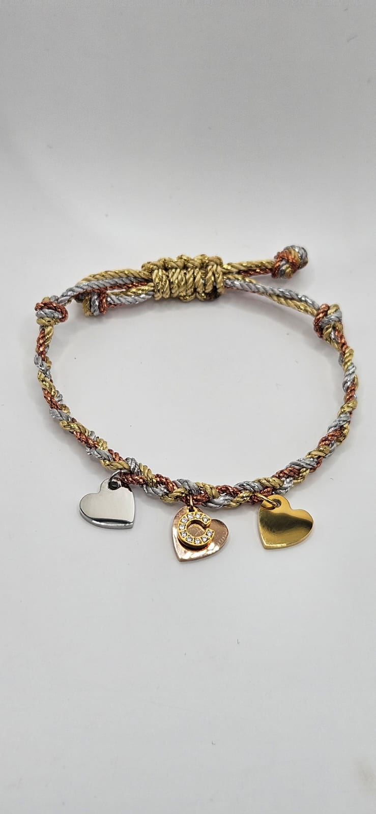 Silver gold and rose gold cord bracelets with gold diamanté initial and 3 tone metal hearts