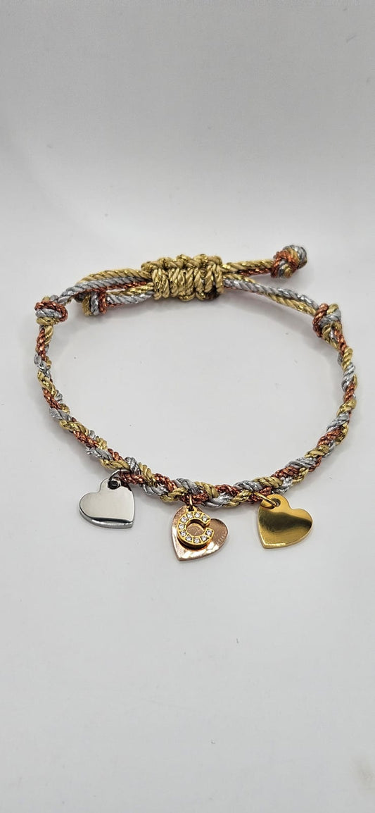 Silver gold and rose gold cord bracelets with gold diamanté initial and 3 tone metal hearts