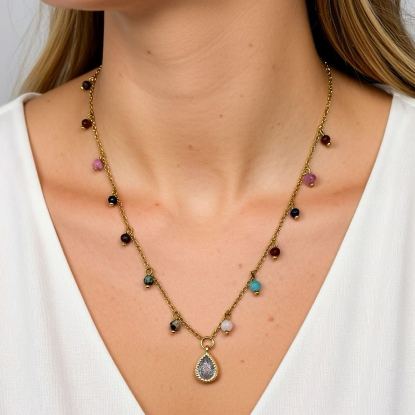Necklace with multicolored gemstones and a teardrop pendant