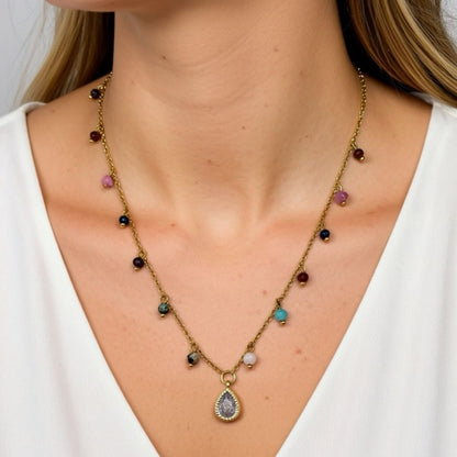 Necklace with multicolored gemstones and a teardrop pendant